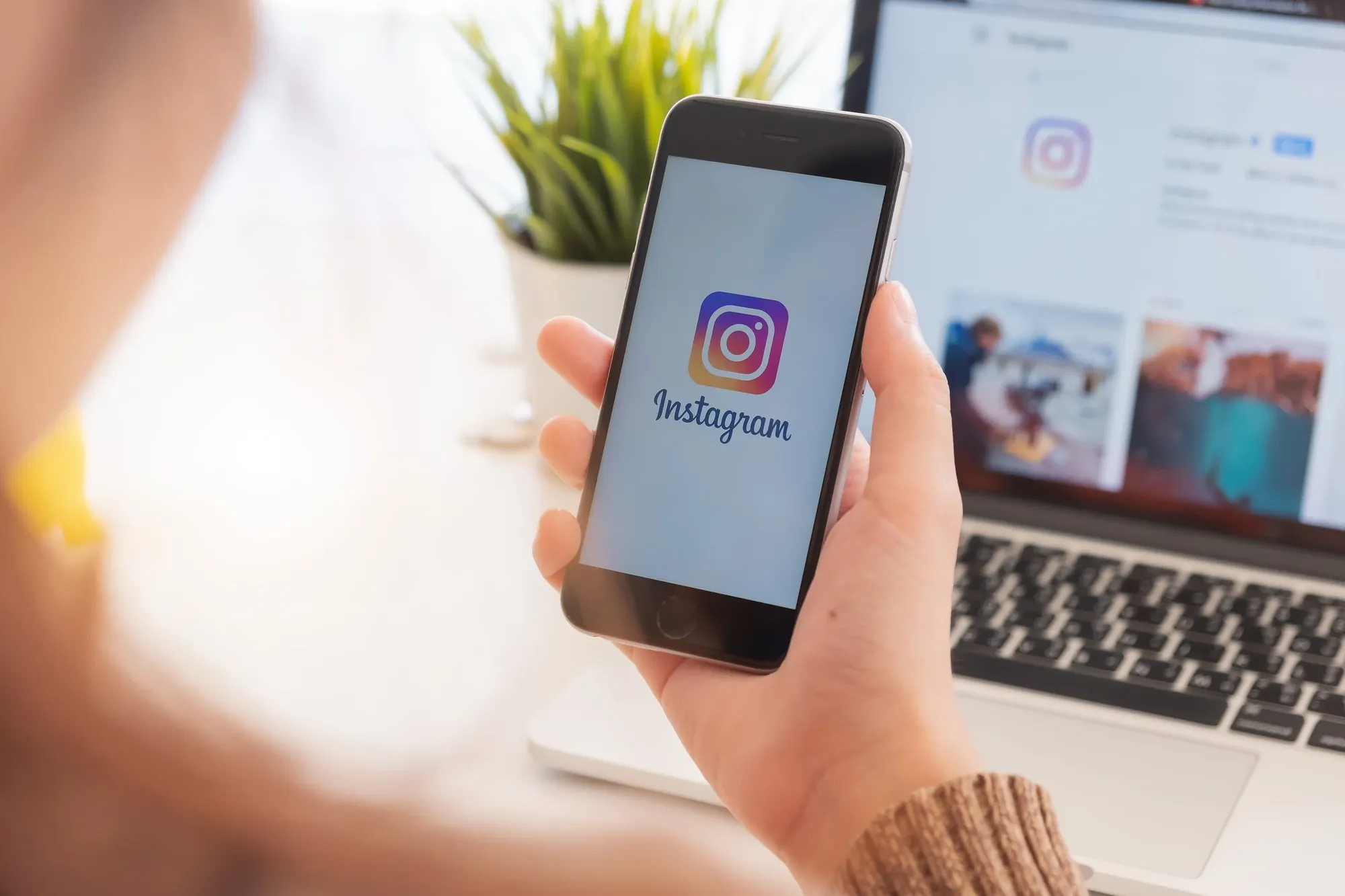 Phone in hand showing Instagram App