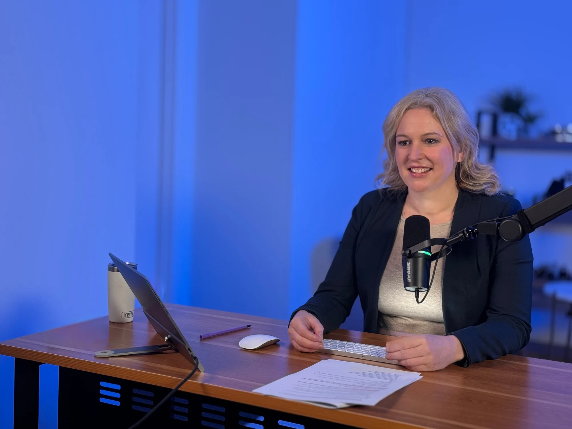 Elizabeth Slade at the microphone recording The Visual Marketing Podcast in the C i Marketing studio